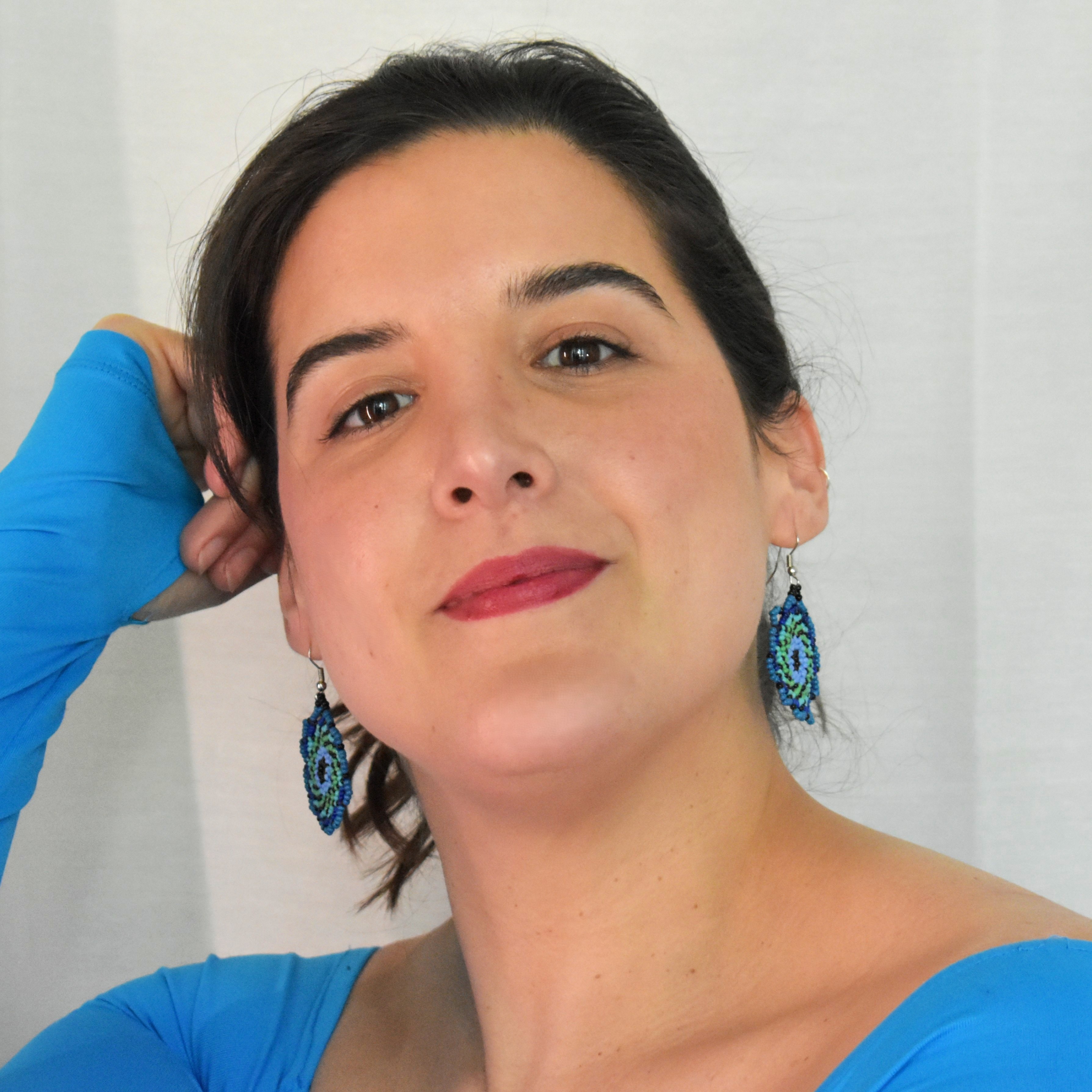 Model wearing blue spiral beaded earrings 