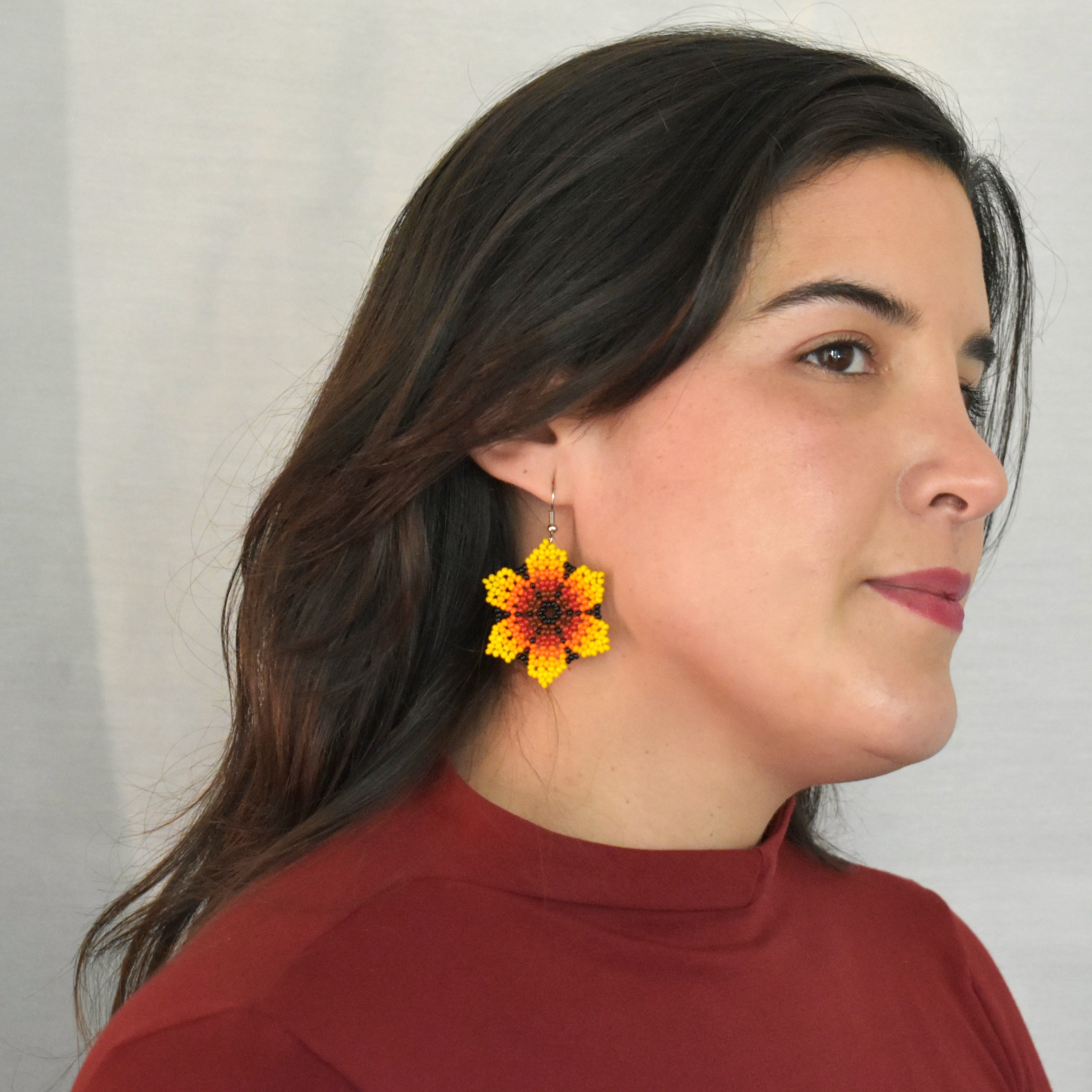 model wearing sunflower beaded earrings