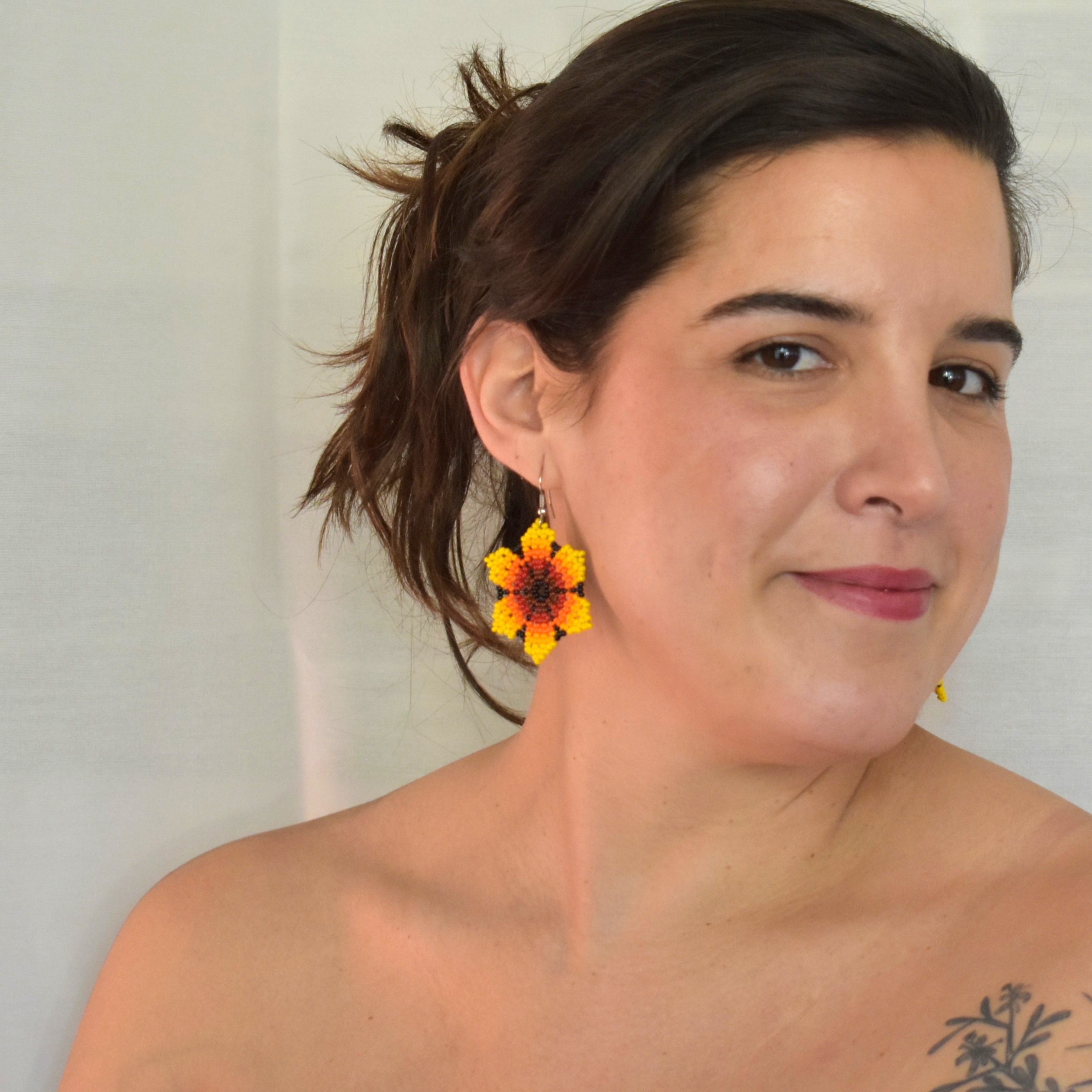 model using sunflower beaded earrings